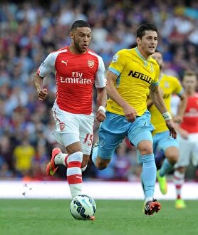 Images Dated 16th August 2014: Arsenal's Alex Oxlade-Chamberlain vs. Crystal Palace's Joel Ward: A Football Showdown