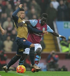 Aston Villa v Arsenal 2015-16 Collection: Arsenal's Alex Oxlade-Chamberlain vs. Idrissa Gana: Intense Battle in Aston Villa vs