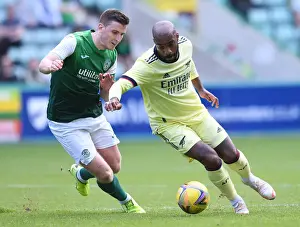 Arsenal's Alexandre Lacazette Faces Off Against Hibernian's Paul Hanlon in 2021-22 Pre-Season Friendly