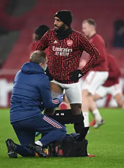 Arsenal's Alexis Lacazette Receives Treatment from Physio Amidst Empty Emirates Stadium (Arsenal v Crystal Palace, Premier League 2021)
