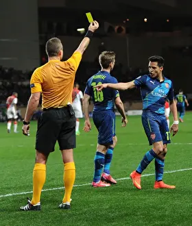Monaco V Arsenal 2014/15 Prints: Arsenal's Alexis Sanchez Argues with Referee Svein Oddvar Moen during Monaco Clash in UEFA Champions League