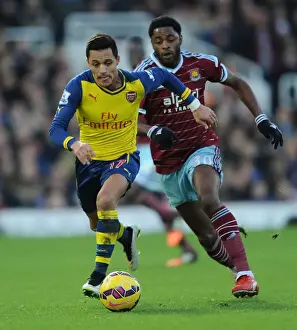 West Ham United V Arsenal 2014-15 Prints: Arsenal's Alexis Sanchez Breaks Past West Ham's Alex Song in Premier League Clash (December 2014)