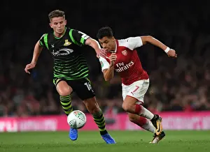Arsenal's Alexis Sanchez Faces Off Against Doncaster's Jordan Houghton in Carabao Cup Clash