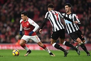 Images Dated 16th December 2017: Arsenal's Alexis Sanchez Faces Off Against Newcastle's Mikel Merino