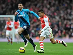 Arsenal V Stoke City 2014-15 Prints: Arsenal's Alexis Sanchez Faces Off Against Stoke's Geoff Cameron in Intense Premier League Clash