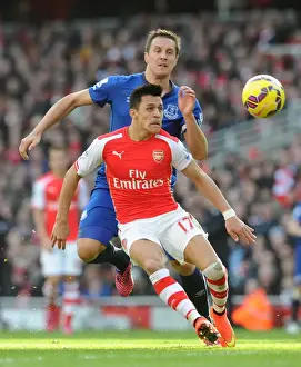 Arsenal Everton 2014-15 Prints: Arsenal's Alexis Sanchez Fends Off Everton's Phil Jagielka in Intense Premier League Clash