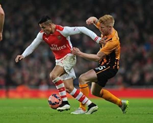 Images Dated 4th January 2015: Arsenal's Alexis Sanchez Fends Off Hull City's Paul McShane in FA Cup Clash