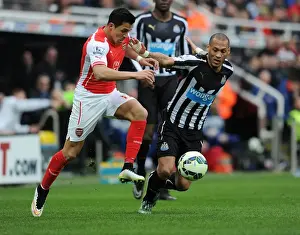 Newcastle United V Arseal 2014/15 Prints: Arsenal's Alexis Sanchez Fends Off Newcastle's Yoan Gouffran During Intense Premier League Clash