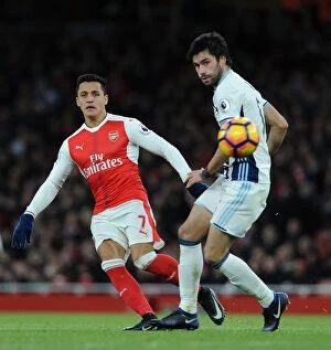 Images Dated 26th December 2016: Arsenal's Alexis Sanchez Fends Off West Brom's Claudio Yacob