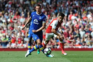 Arsenal V Everton 2016-17 Prints: Arsenal's Alexis Sanchez Fouls by Everton's Phil Jagielka in Intense Premier League Clash