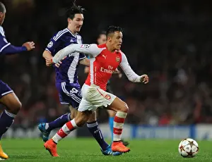 Arsenal V Anderlecht 2014/15 Prints: Arsenal's Alexis Sanchez Outmaneuvers Sacha Kljestan in 2014 Champions League Clash