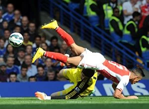 Chelsea v Arsenal 2014-15 Collection: Arsenal's Alexis Sanchez Stumbles Against Chelsea's Thibaut Courtois - Premier League 2014-15