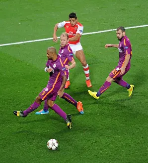 Arsenal V Galatasaray 2014/15 Champions League Prints: Arsenal's Alexis Sanchez Takes On Galatasaray's Defense in 2014 Champions League Clash