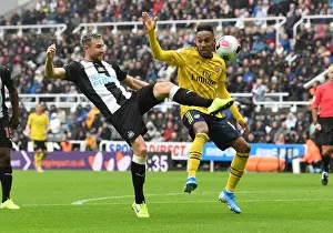 Arsenal's Aubameyang Faces Off Against Newcastle's Dummett in Premier League Clash