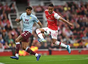 Arsenal's Aubameyang Faces Off Against Villa's Mings in Intense Premier League Clash