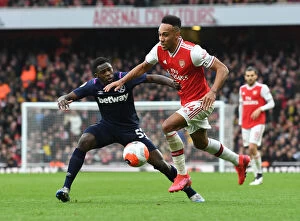 Arsenal v West Ham United 2019-20 Collection: Arsenal's Aubameyang Faces Off Against West Ham's Nhakia in Premier League Clash