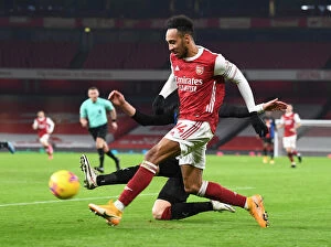 Arsenal v Crystal Palace 2020-21 Collection: Arsenal's Aubameyang Shines Alone: A Beacon in Empty Emirates During Arsenal vs