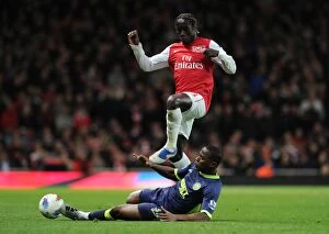 Images Dated 16th April 2012: Arsenal's Bacary Sagna Jumps Over Wigan's Figueroa during the 2011-12 Premier League Match