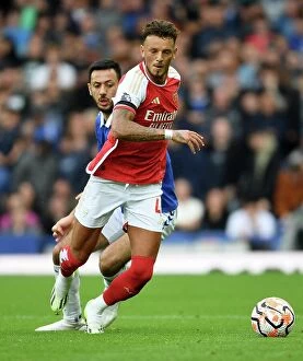 Everton v Arsenal 2023-24 Collection: Arsenal's Ben White Fends Off Everton's Dwight McNeil in Premier League Clash (2023-24)
