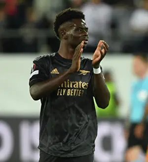 FC Zurich V Arsenal 2022-23 Prints: Arsenal's Bukayo Saka Celebrates with Fans after UEFA Europa League Win over FC Zurich