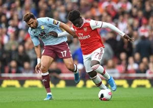 Arsenal v Aston Villa 2019-20 Collection: Arsenal's Bukayo Saka Clashes with Aston Villa's Trezeguet in Premier League Showdown