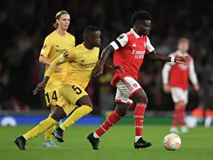 Arsenal V FK Bodo/Glimt 2022-23 Prints: Arsenal's Bukayo Saka Clashes with Brice Wenbangomo in Europa League Battle