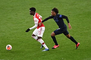 Images Dated 23rd February 2020: Arsenal's Bukayo Saka Clashes with Everton's Alex Iwobi in Premier League Showdown