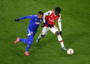 Arsenal V Olympiacos 2019-20 Prints: Arsenal's Bukayo Saka Clashes with Olympiacos Bruno Gaspar in Europa League Showdown