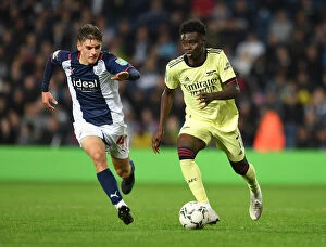 Images Dated 25th August 2021: Arsenal's Bukayo Saka Clashes with Tom Fellows in Carabao Cup Battle at West Bromwich Albion