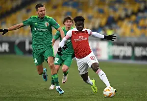 FC Vorskla Poltava V Arsenal 2018-19 Prints: Arsenal's Bukayo Saka Clashes with Vyacheslav Sharpar in Europa League Battle