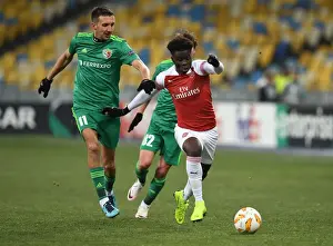 FC Vorskla Poltava V Arsenal 2018-19 Prints: Arsenal's Bukayo Saka Clashes with Vyacheslav Sharpar in Europa League Showdown