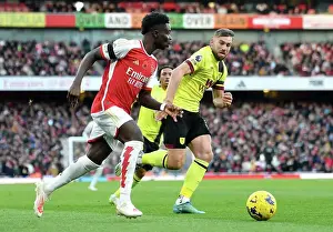 Arsenal's Bukayo Saka Evades Burnley's Charlie Taylor: Premier League Showdown at Emirates Stadium (2023-24)