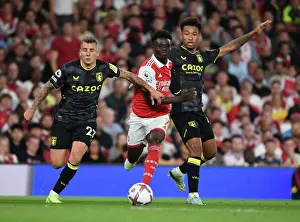 Arsenal's Bukayo Saka Faces Off Against Aston Villa's Lucas Digne and Boubacar Bernard Kamara in 2022-23 Premier League Clash