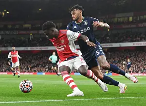 Arsenal's Bukayo Saka Faces Off Against Aston Villa's Tyrone Mings in Premier League Showdown
