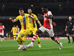 Images Dated 18th October 2021: Arsenal's Bukayo Saka Faces Off Against Crystal Palace's Joel Ward in Premier League Clash