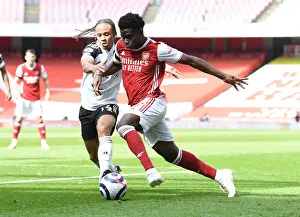 Arsenal's Bukayo Saka Faces Off Against Fulham's Bobby De Cordova-Reid in Empty Emirates Stadium, Premier League 2020-21