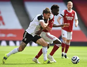 Arsenal's Bukayo Saka Faces Off Against Fulham's Joe Bryan in Empty Emirates Stadium, Premier League 2020-21