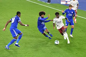 Arsenal's Bukayo Saka Faces Off Against Leicester City's Daniel Amartey and Hamza Choudhury in Carabao Cup Clash