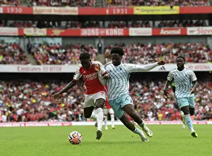 Arsenal's Bukayo Saka Faces Off Against Nottingham Forest's Ola Aina in 2023-24 Premier League Clash