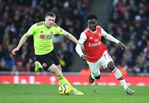 Arsenal V Sheffield United 2019-20 Prints: Arsenal's Bukayo Saka Faces Off Against Sheffield United's John Lundstram in Premier League Clash