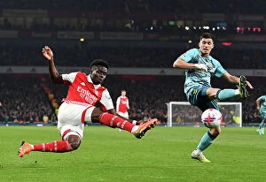 Images Dated 22nd April 2023: Arsenal's Bukayo Saka Faces Off Against Southampton's Romain Perraud in Intense Premier League