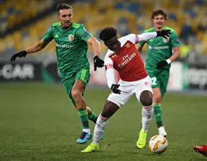 FC Vorskla Poltava V Arsenal 2018-19 Prints: Arsenal's Bukayo Saka Faces Off Against Vyacheslav Sharpar in Europa League Clash
