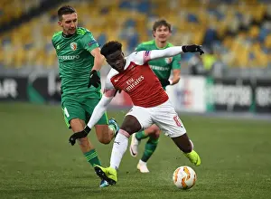 FC Vorskla Poltava V Arsenal 2018-19 Prints: Arsenal's Bukayo Saka Faces Off Against Vyacheslav Sharpar in Europa League Clash