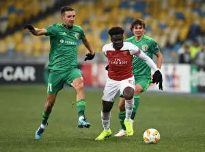 FC Vorskla Poltava V Arsenal 2018-19 Prints: Arsenal's Bukayo Saka Faces Off Against Vyacheslav Sharpar in Europa League Clash