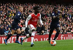 Arsenal's Bukayo Saka Faces Off Against West Ham's Jeremy Ngakia in Premier League Clash