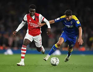 Arsenal V AFC Wimbledon 2021-22 Prints: Arsenal's Bukayo Saka Faces Off Against Wimbledon's Will Nightingale in Carabao Cup Clash