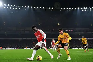 Arsenal's Bukayo Saka Faces Off Against Wolverhampton Wanderers Hugo Bueno in 2023-24 Premier League Clash