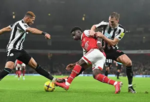 Arsenal V Newcastle United 2022-23 Prints: Arsenal's Bukayo Saka Fends Off Newcastle's Joelinton