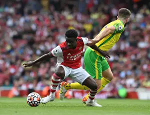 Arsenal V Norwich City 2021-22 Prints: Arsenal's Bukayo Saka Fends Off Norwich's Grant Hanley During Premier League Clash