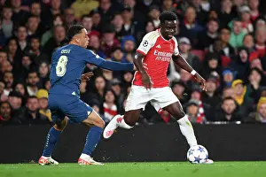 Arsenal V PSV Eindhoven 2023-24 Prints: Arsenal's Bukayo Saka Fends Off PSV's Sergino Dest in Champions League Clash